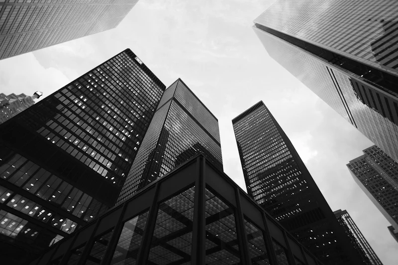 Looking up through the geometric lines of modern skyscrapers